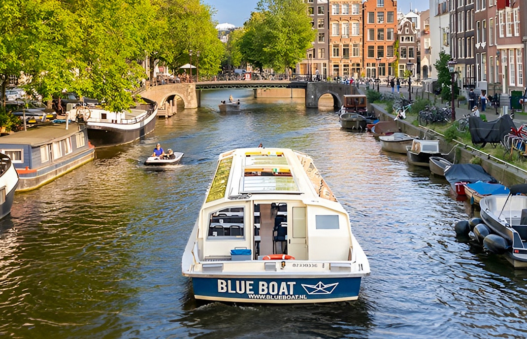 Amsterdam canal cruise with views of historic buildings and iconic bridges.