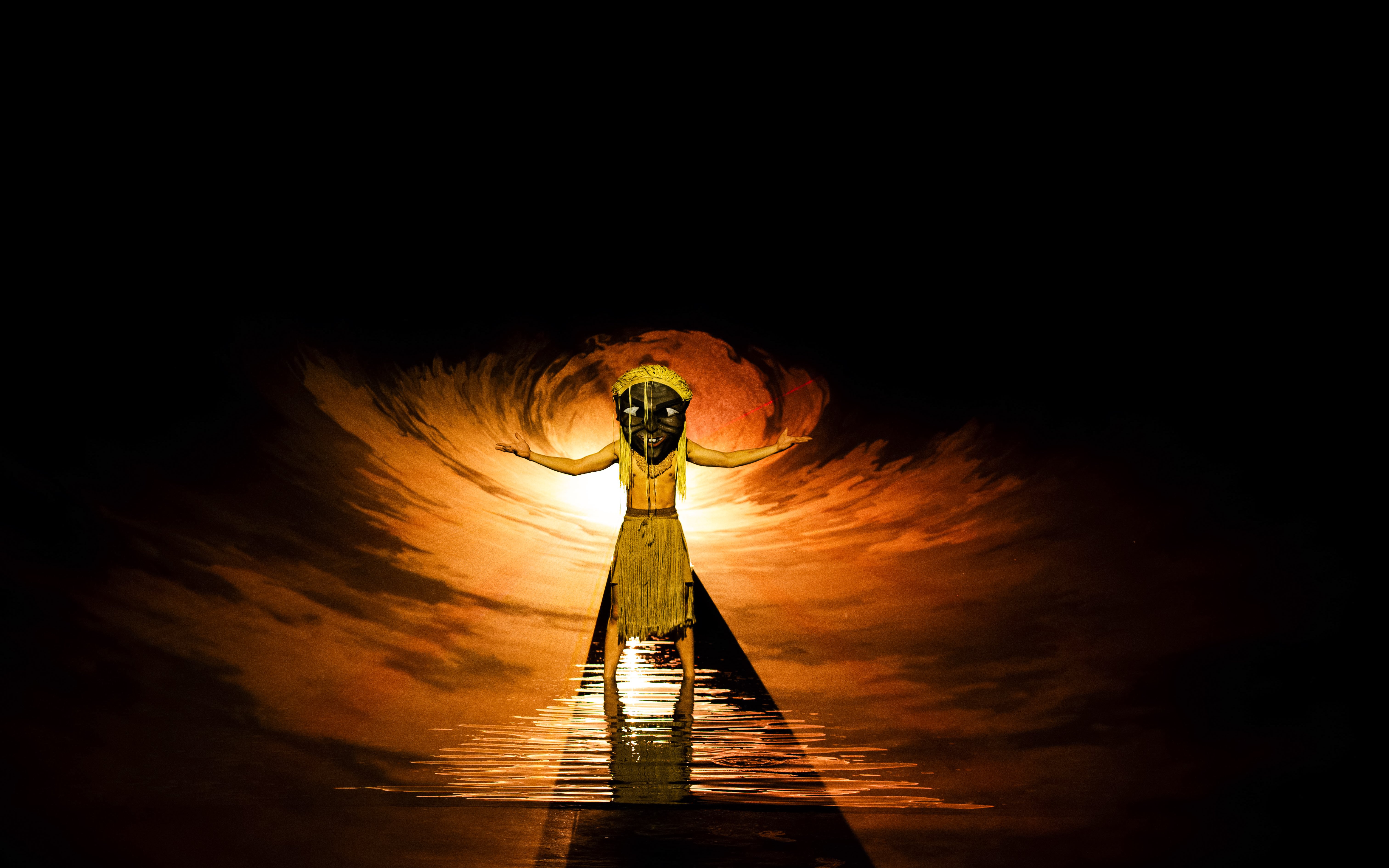 Performer in traditional attire on stage at The Legacy of a Generation Show.
