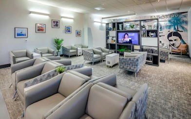Aspire Lounge seating area with modern decor at San Diego International Airport.
