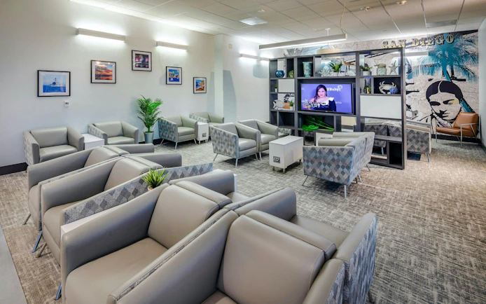 Aspire Lounge seating area with modern decor at San Diego International Airport.