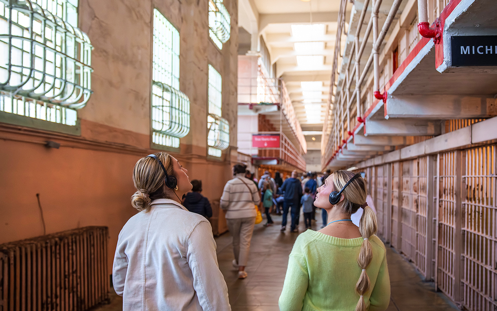 Guests touring Alcatraz Island prison cellhouses with audio guides.