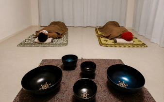 Lying-down meditation with sound bowls in a Kyoto relaxation session.