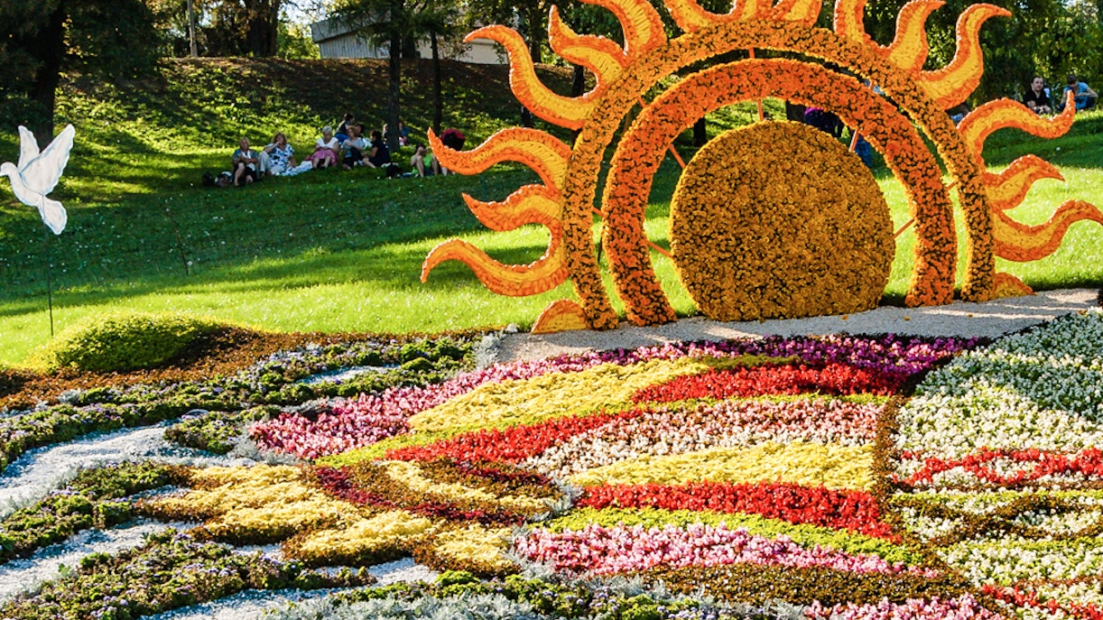 Floral sun sculpture and colorful flower beds at Mainau Flower Island.
