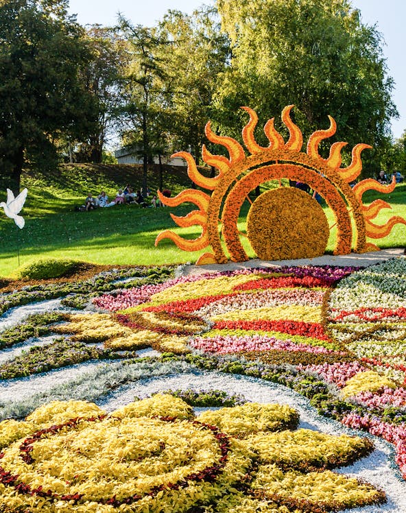 Floral sun sculpture and colorful flower beds at Mainau Flower Island.