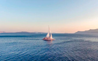 Catamaran sailing on the Aegean Sea during a Santorini cruise.