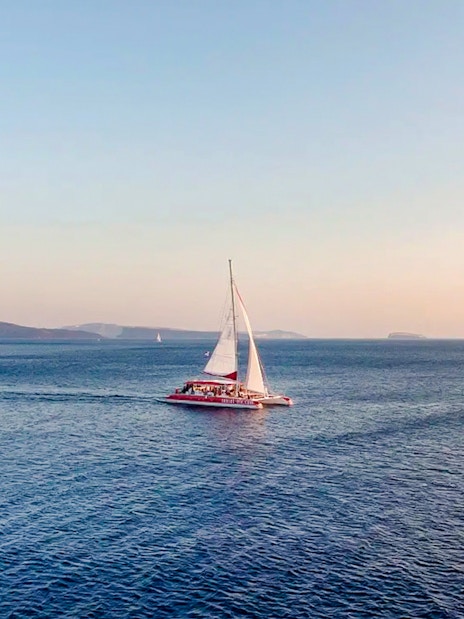 Catamaran sailing on the Aegean Sea during a Santorini cruise.