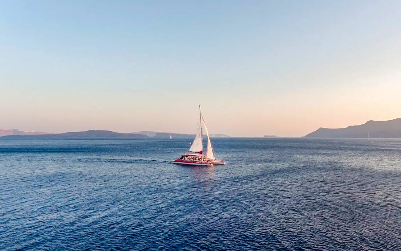 Catamaran sailing on the Aegean Sea during a Santorini cruise.