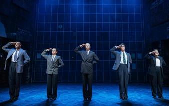 Performers saluting on stage during Operation Mincemeat, Broadway.