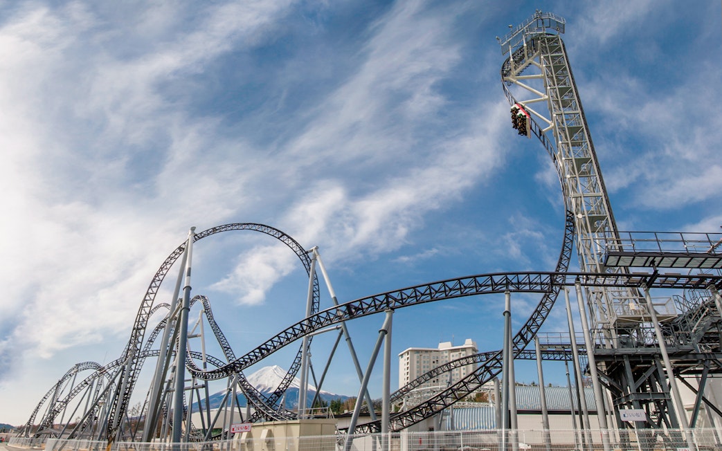 Roller coaster at Fuji-Q Highland with Mount Fuji in the background.