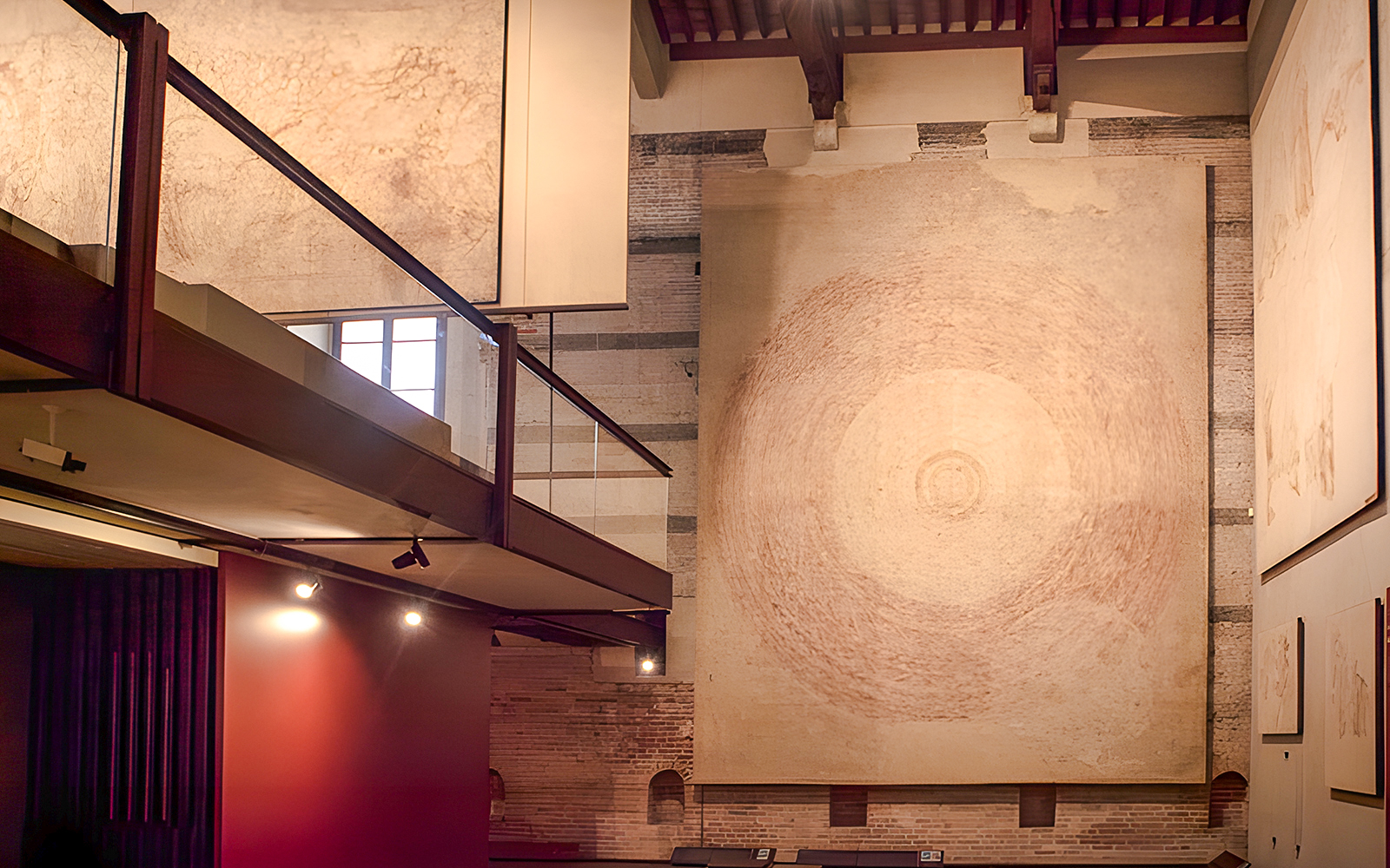 Paintings displayed at Sinopie Museum in Pisa, featuring large circular artwork.