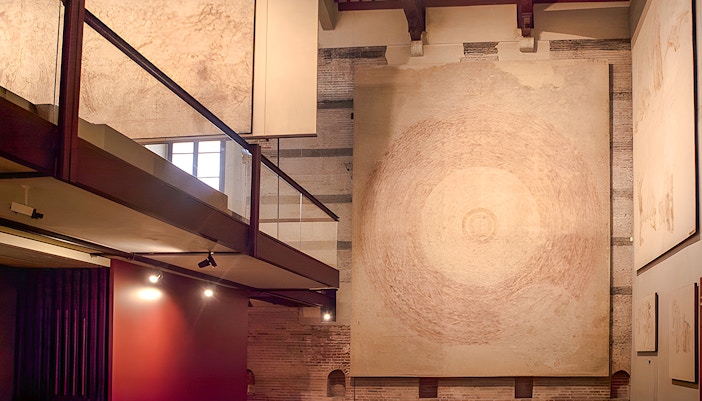 Paintings displayed at Sinopie Museum in Pisa, featuring large circular artwork.