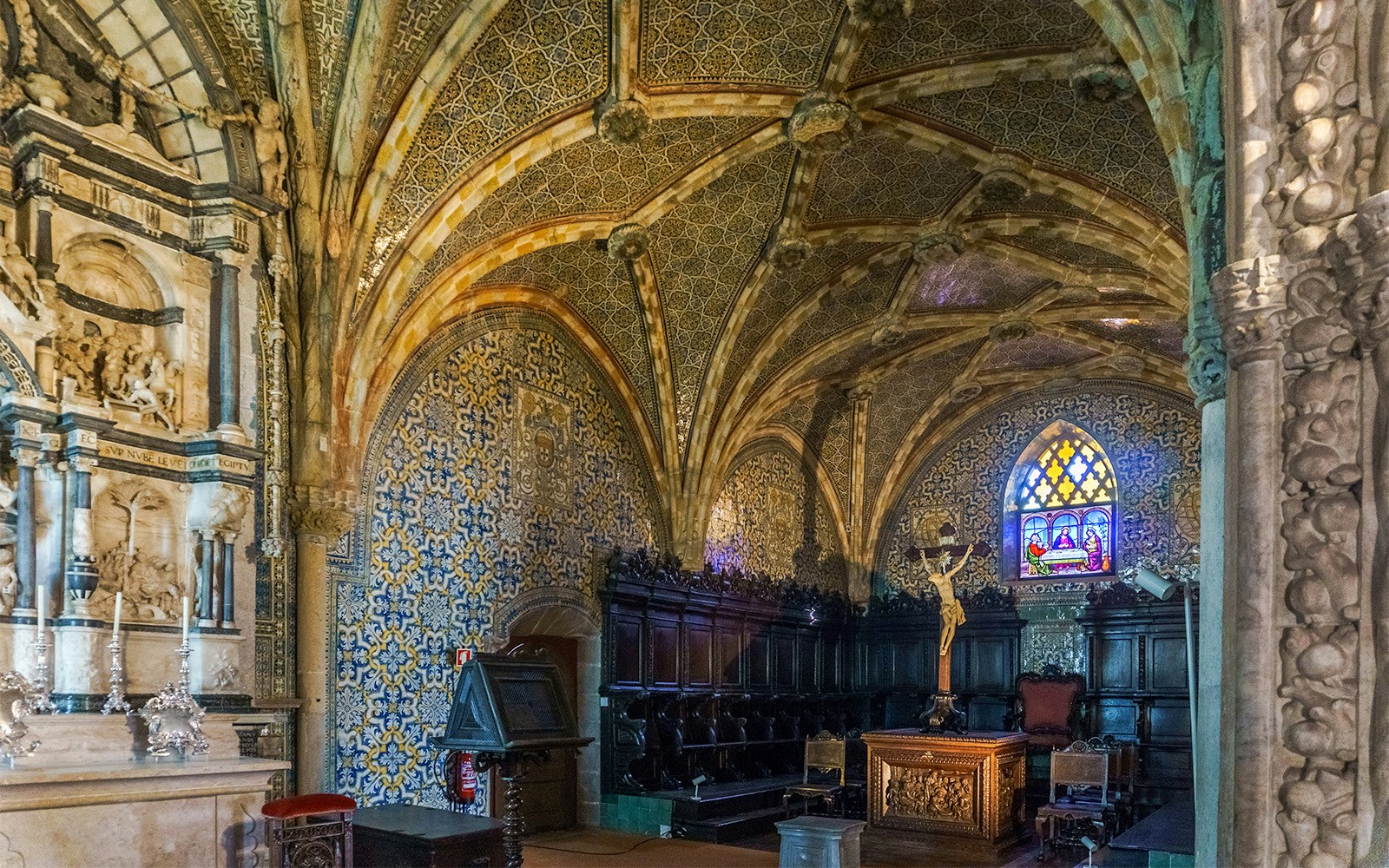 Pena Palace chapel interior with intricate arches and stained glass windows, Sintra, Portugal.