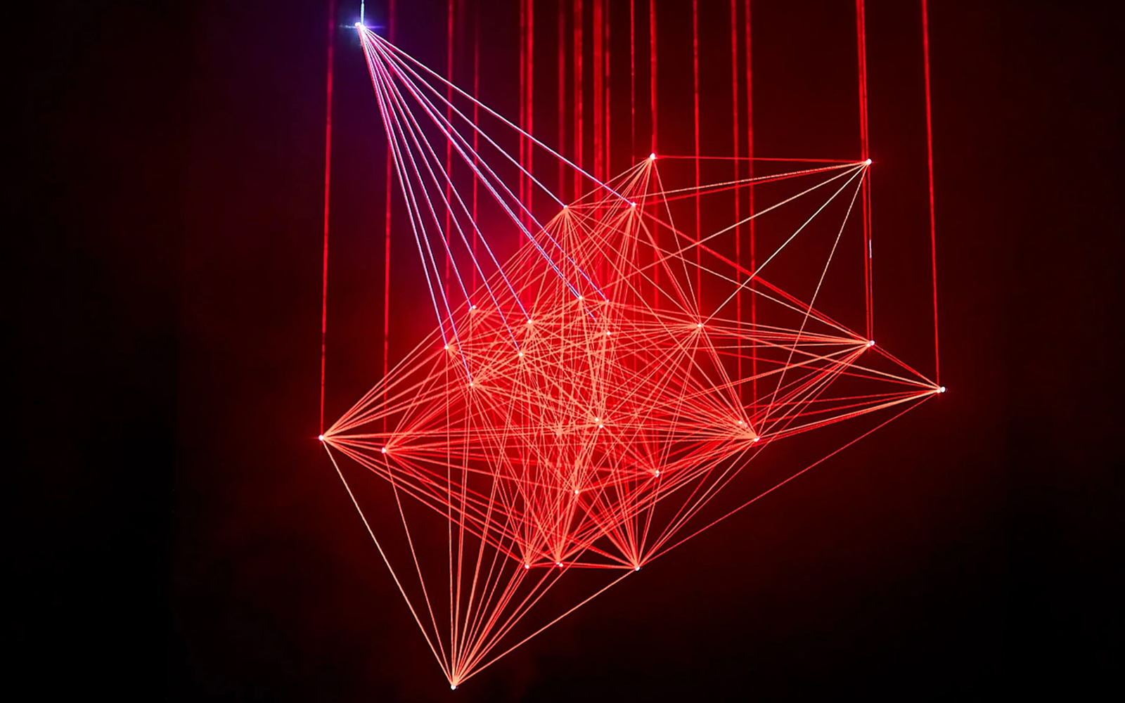 Red laser light installation at Light Art Museum exhibit.