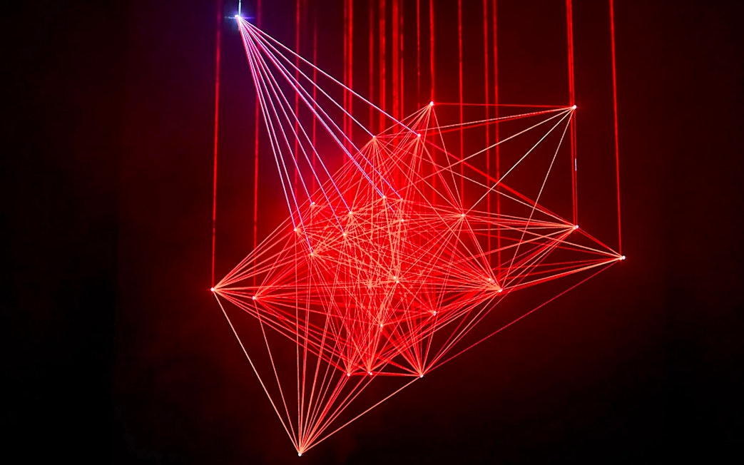 Red laser light installation at Light Art Museum exhibit.