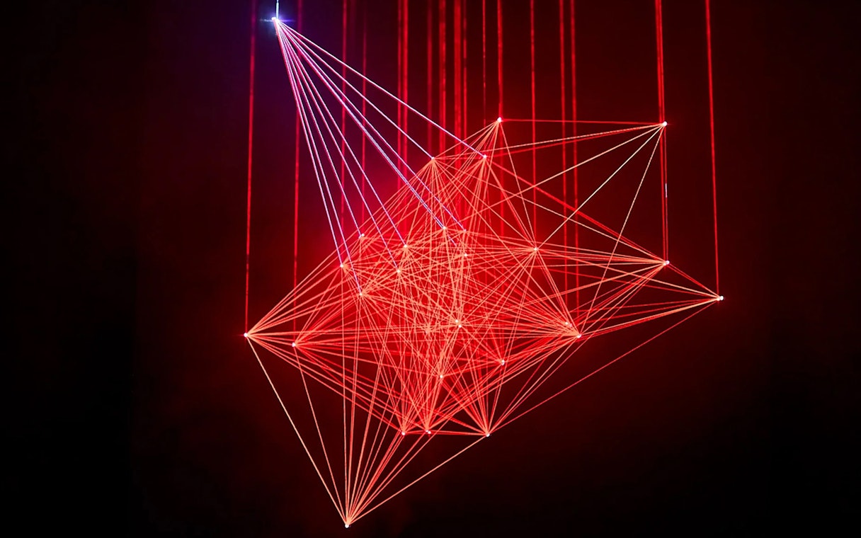 Red laser light installation at Light Art Museum exhibit.