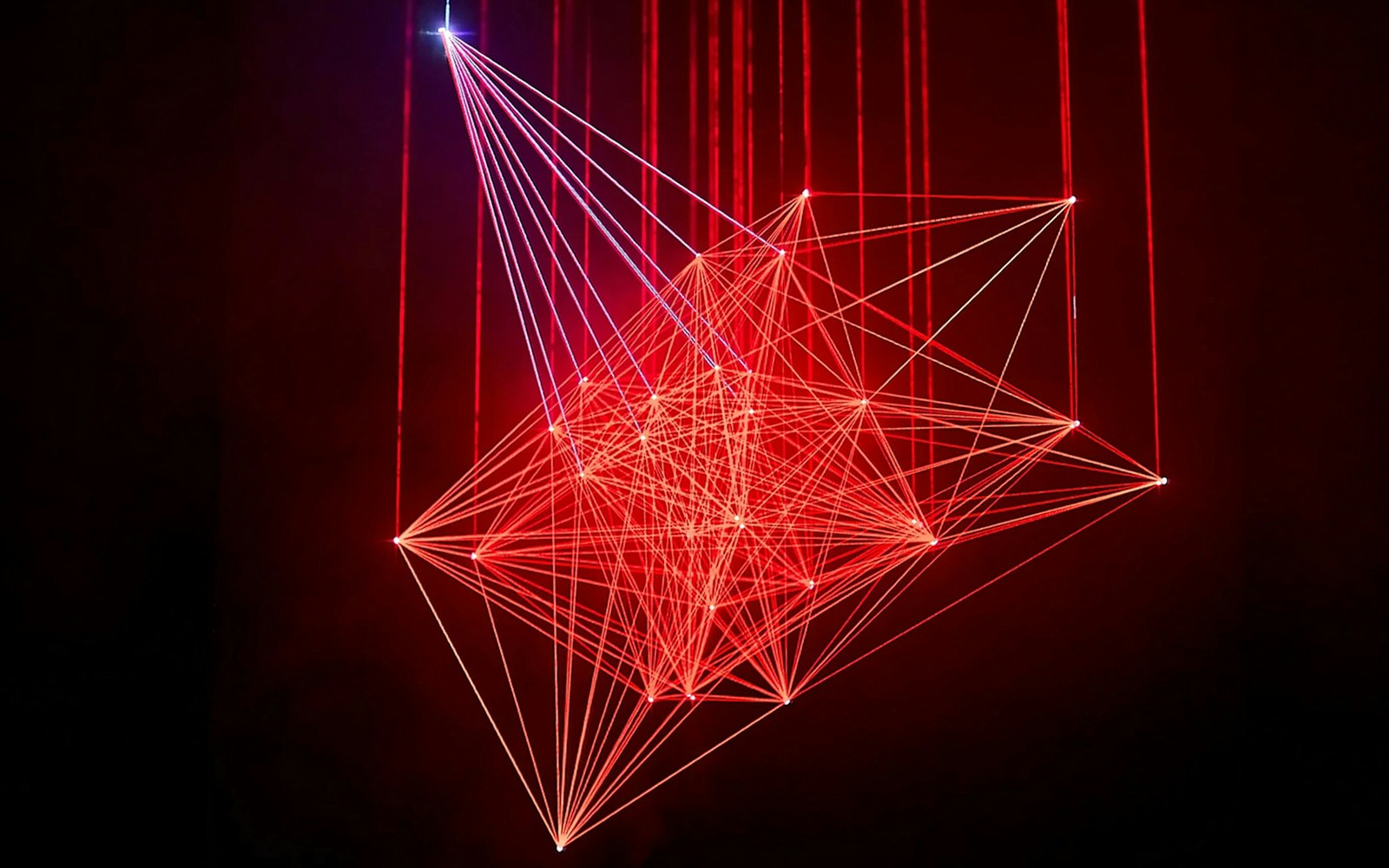 Red laser light installation at Light Art Museum exhibit.