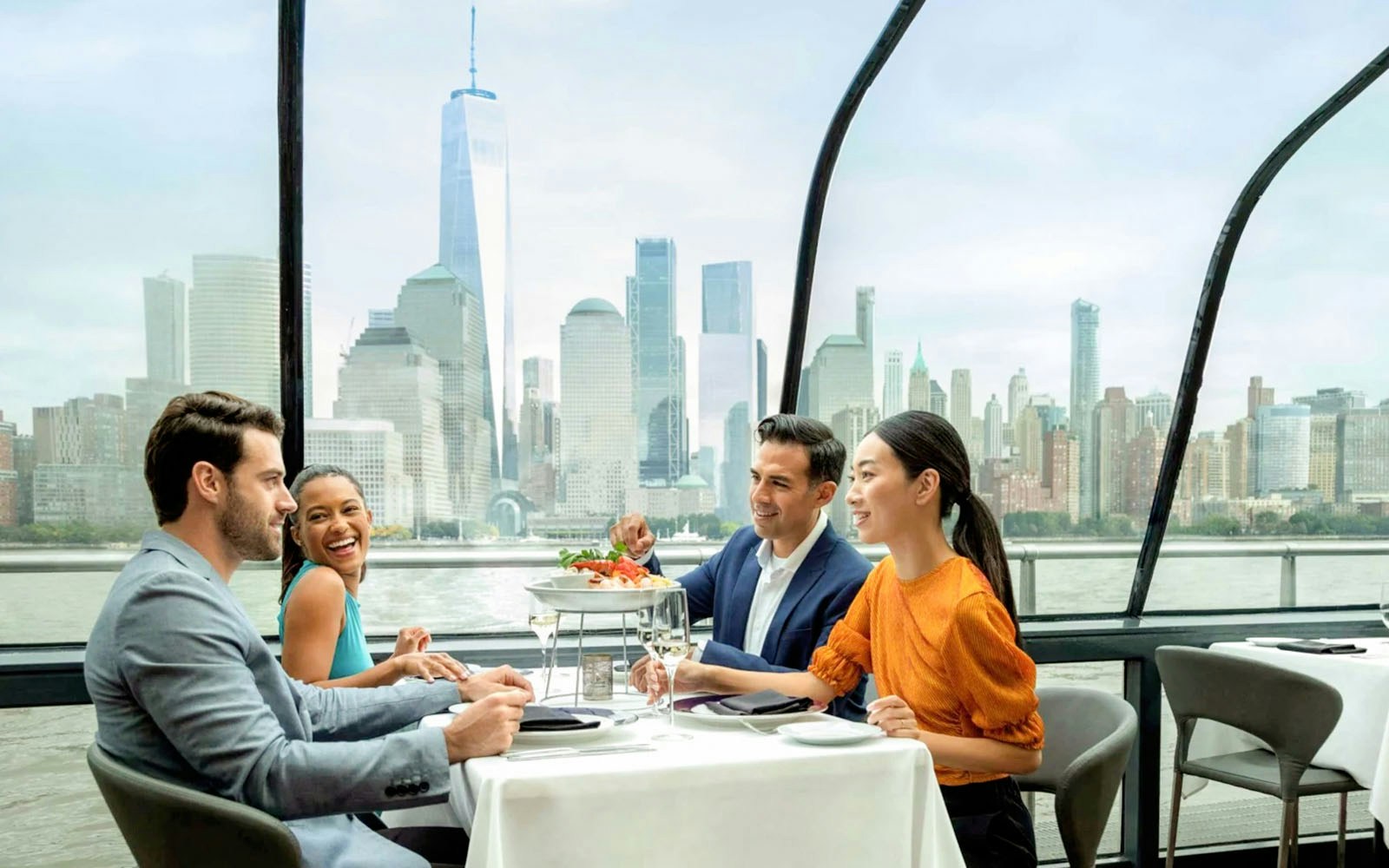 Elegant dining setup on a New York City cruise with skyline views.