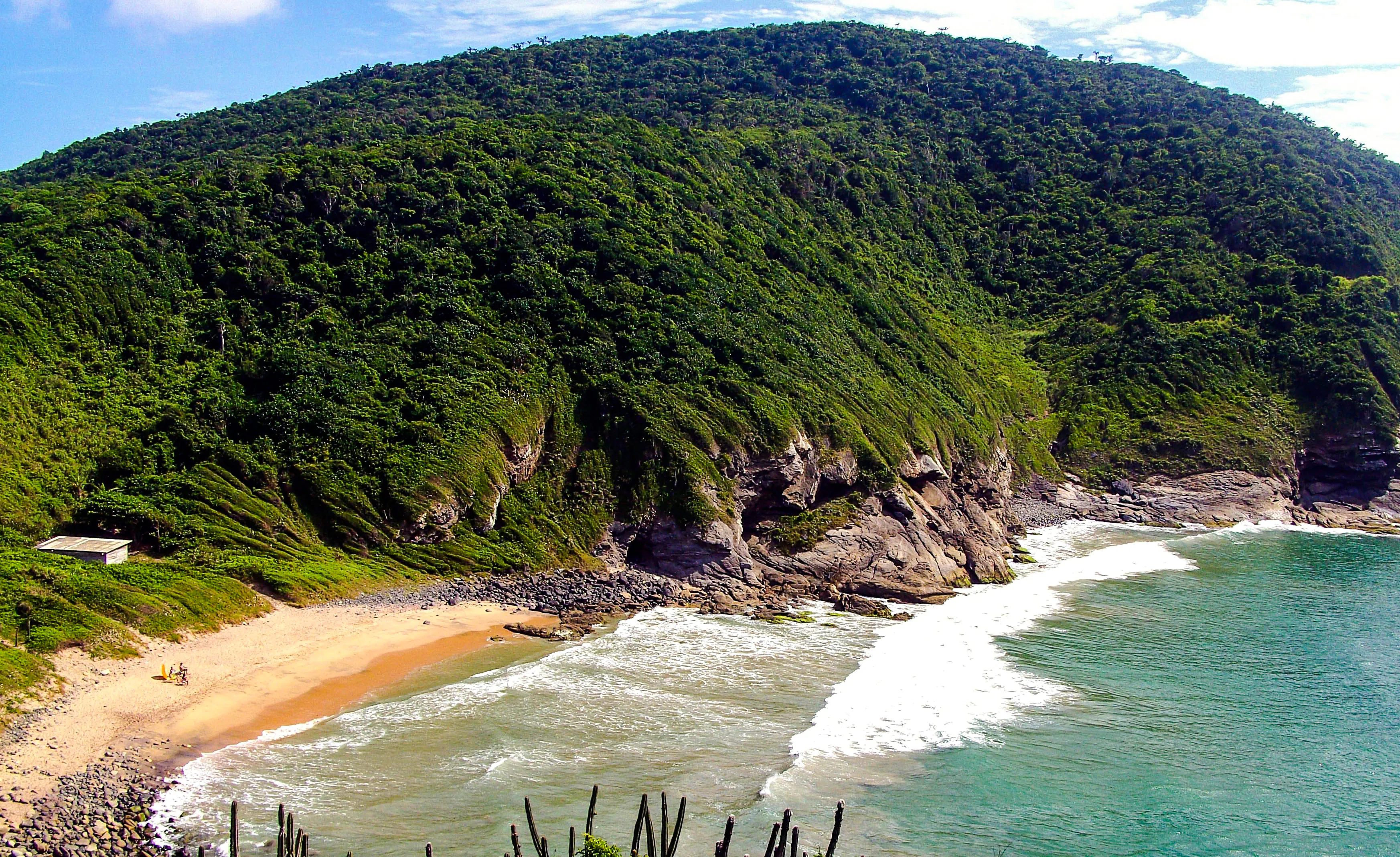 Emerências beach with lush green hills and rocky cliffs, José Gonçalves, Rio de Janeiro.