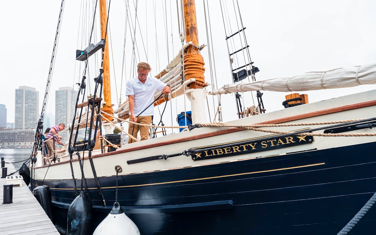 Liberty Star docked at Boston Harbor with crew preparing the ship.