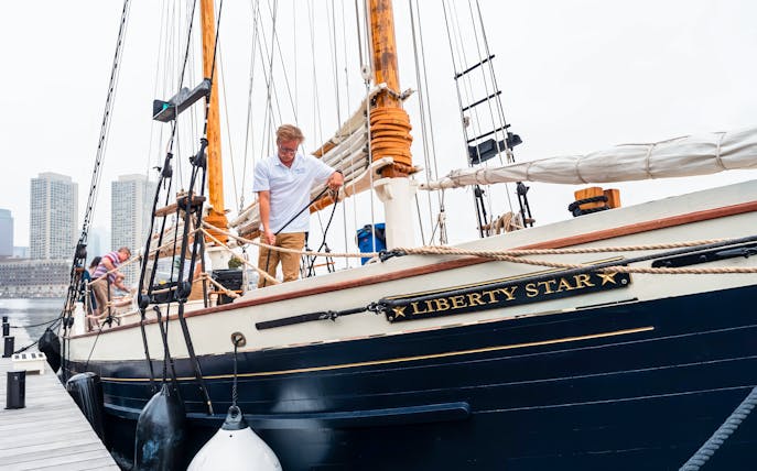 Liberty Star docked at Boston Harbor with crew preparing the ship.