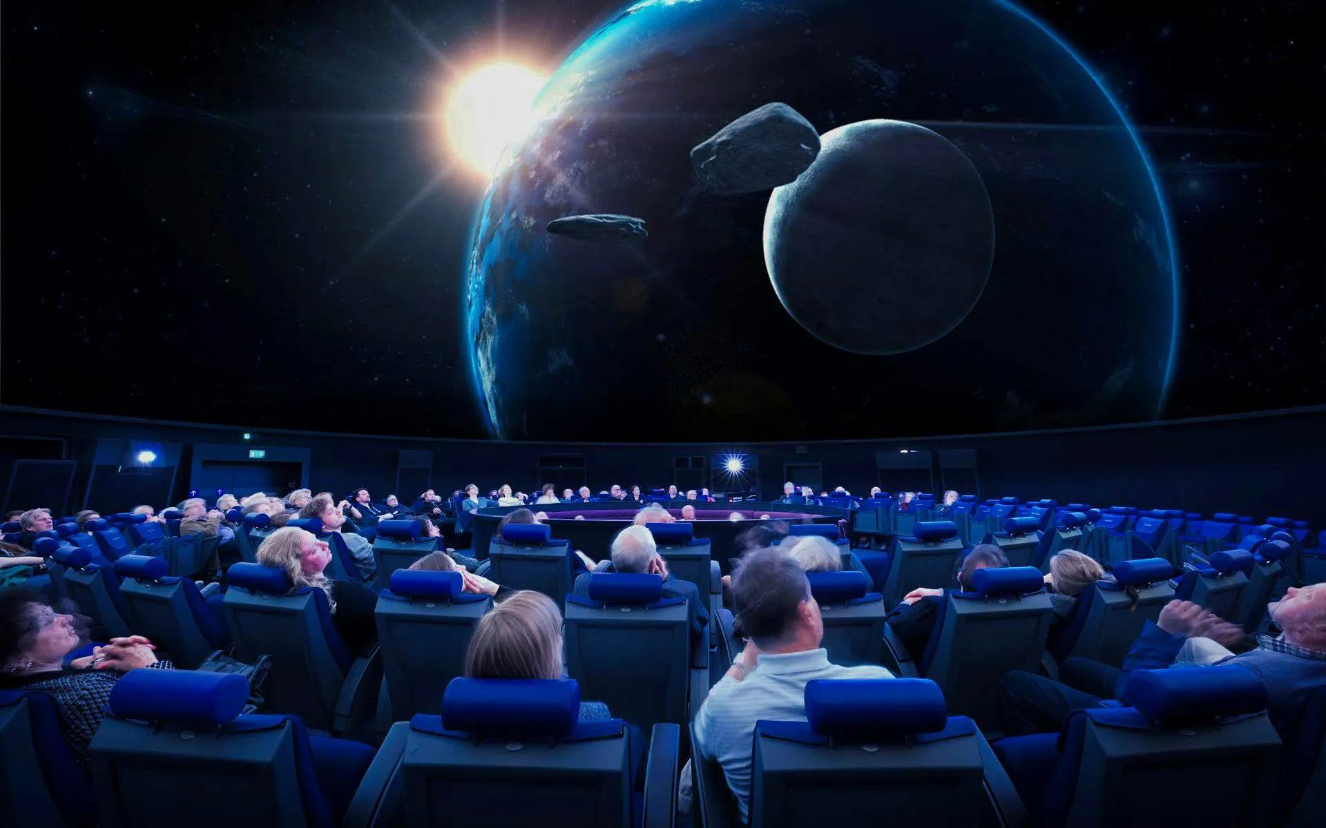 Guests watching a space presentation at the Planetarium Museum of Transport in Lucerne.