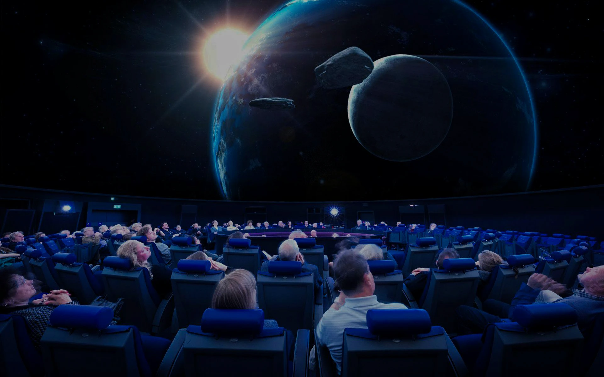 Guests watching a space presentation at the Planetarium Museum of Transport in Lucerne.