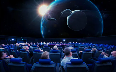 Guests watching a space presentation at the Planetarium Museum of Transport in Lucerne.