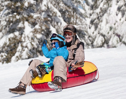 mother and son on tobbogan slide at mount titlis