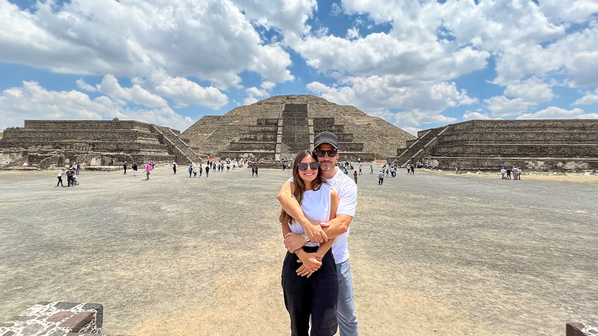 Tourists walking along Avenue of the Dead, viewing Pyramid of the Moon, Teotihuacan, Mexico.