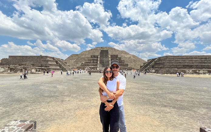 Tourists at Avenue of the Dead, Teotihuacan, with Pyramid of the Moon in the background.