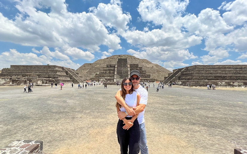 Tourists at Avenue of the Dead, Teotihuacan, with Pyramid of the Moon in the background.