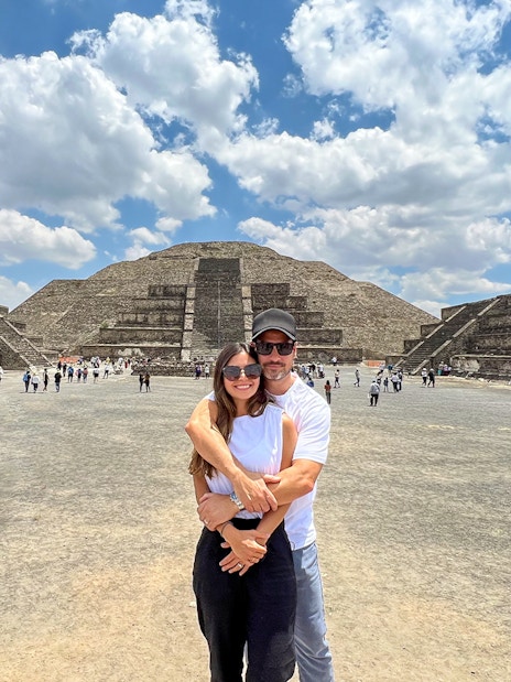 Tourists at Avenue of the Dead, Teotihuacan, with Pyramid of the Moon in the background.