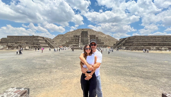 Tourists at Avenue of the Dead, Teotihuacan, with Pyramid of the Moon in the background.