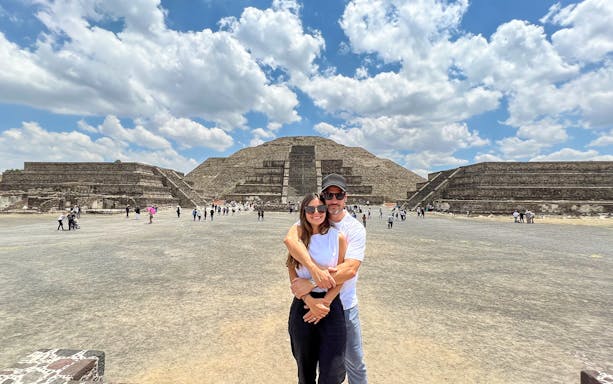 Tourists at Avenue of the Dead, Teotihuacan, with Pyramid of the Moon in the background.