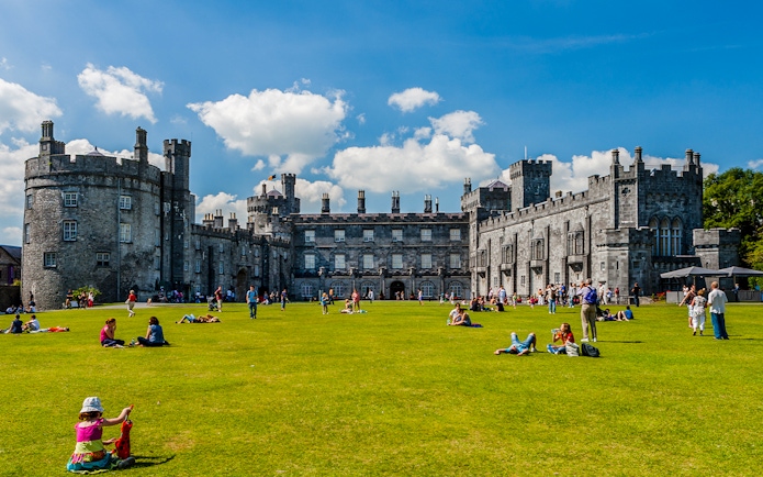 Visitors enjoying the gardens in front of Kilkenny Castle, Ireland.