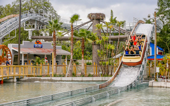 People enjoying a log flume ride at an Orlando theme park, part of the Orlando Explorer Pass.
