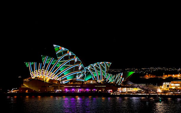 Sydney Opera House illuminated during Vivid Sydney cruise.