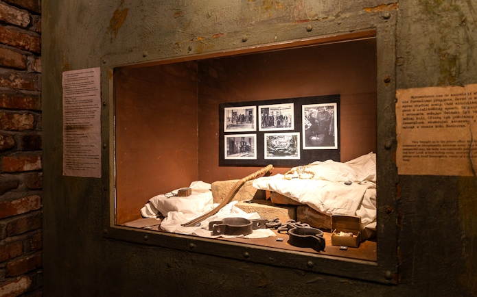 Artifacts and photos displayed inside Oskar Schindler's Factory exhibit in Krakow.