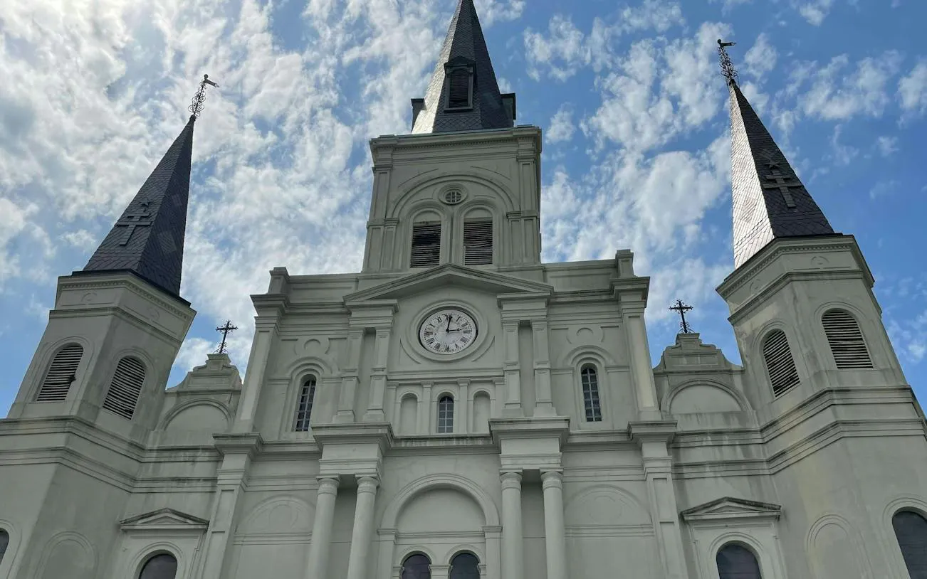 St. Louis Cathedral spires against a blue sky, New Orleans French Quarter.