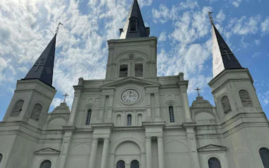 St. Louis Cathedral spires against a blue sky, New Orleans French Quarter.