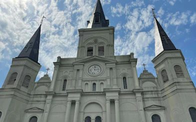 St. Louis Cathedral spires against a blue sky, New Orleans French Quarter.