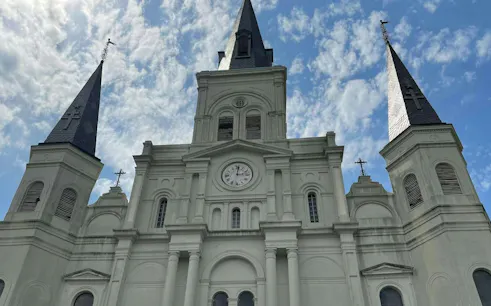 St. Louis Cathedral spires against a blue sky, New Orleans French Quarter.