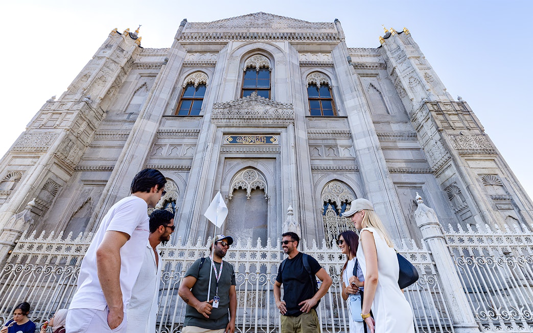 Tour group outside ornate facade of Topkapi Palace, Istanbul.