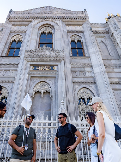 Tour group outside ornate facade of Topkapi Palace, Istanbul.