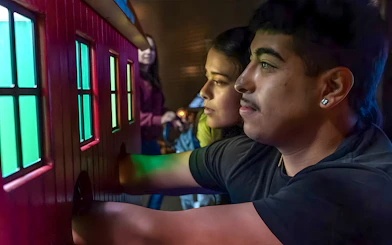 Visitors interacting with a colorful exhibit at the Exploratorium in San Francisco.
