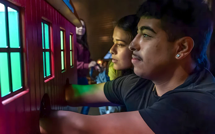 Visitors interacting with a colorful exhibit at the Exploratorium in San Francisco.