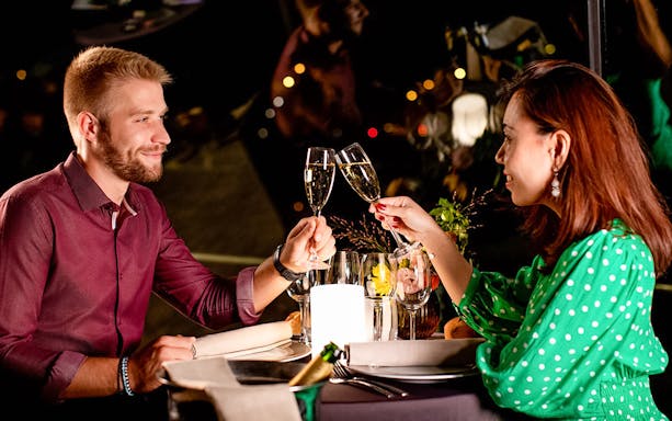 Couple toasting with champagne on Bateaux Parisiens, Paris New Year's Eve 2025.
