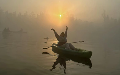 Kayaker enjoying sunrise on Xochimilco canal with local guide.