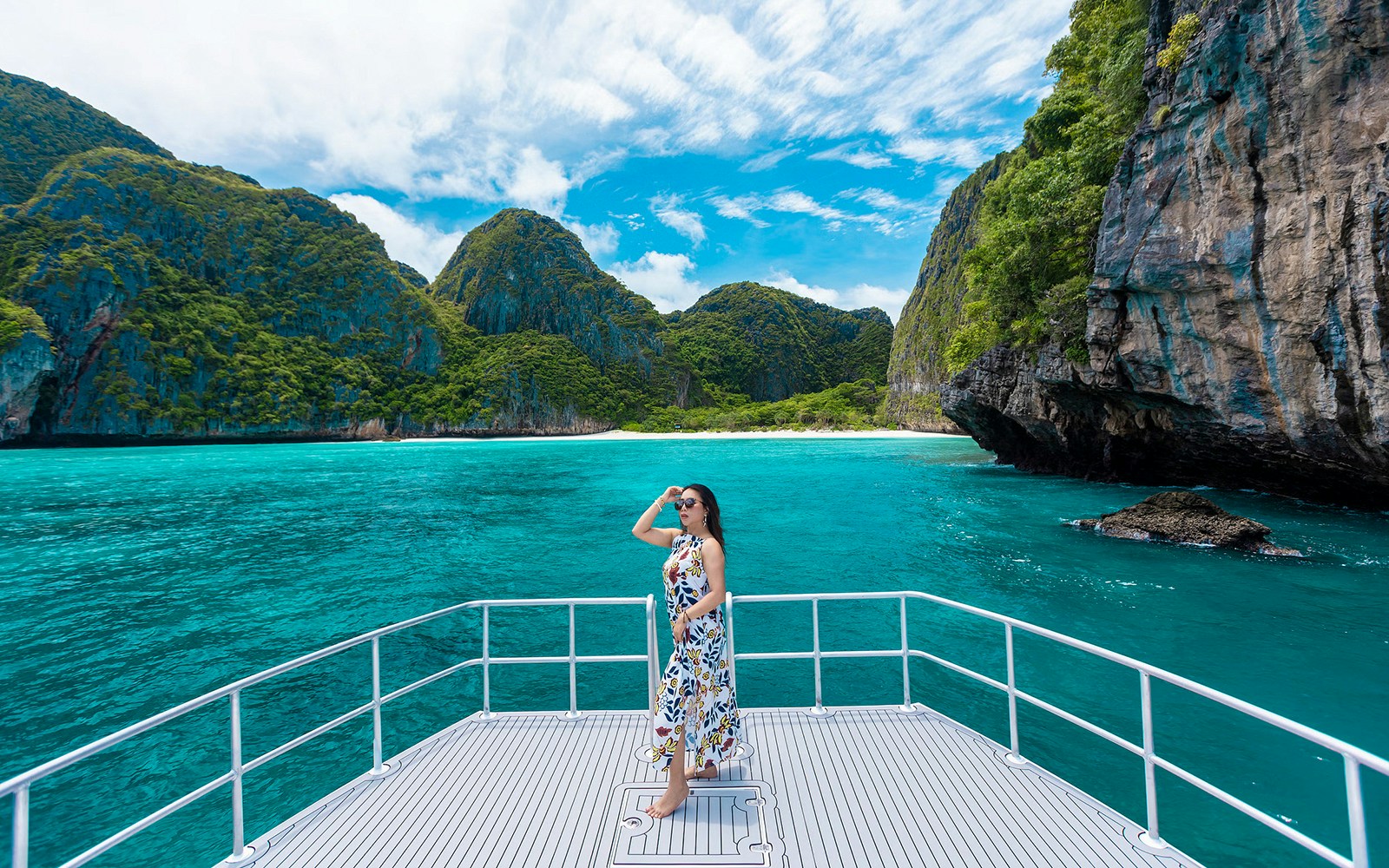 Lady on a catamaran enjoying the view at Maya Bay