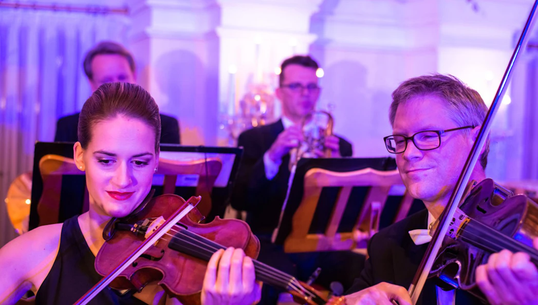 Musicians playing violins at Mozart and Strauss concert in Kursalon Vienna.
